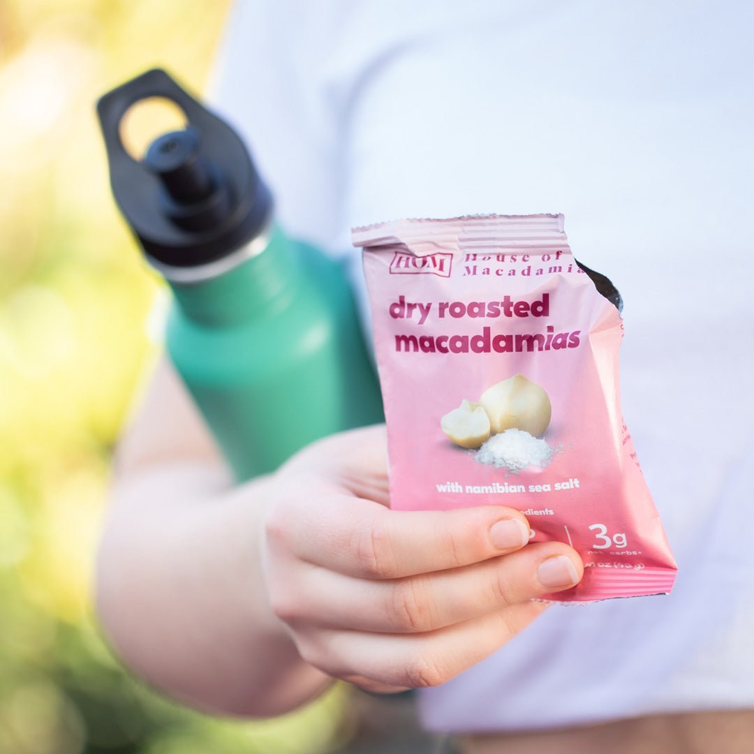 woman holding dry roasted Namibian sea salt macadamia nuts