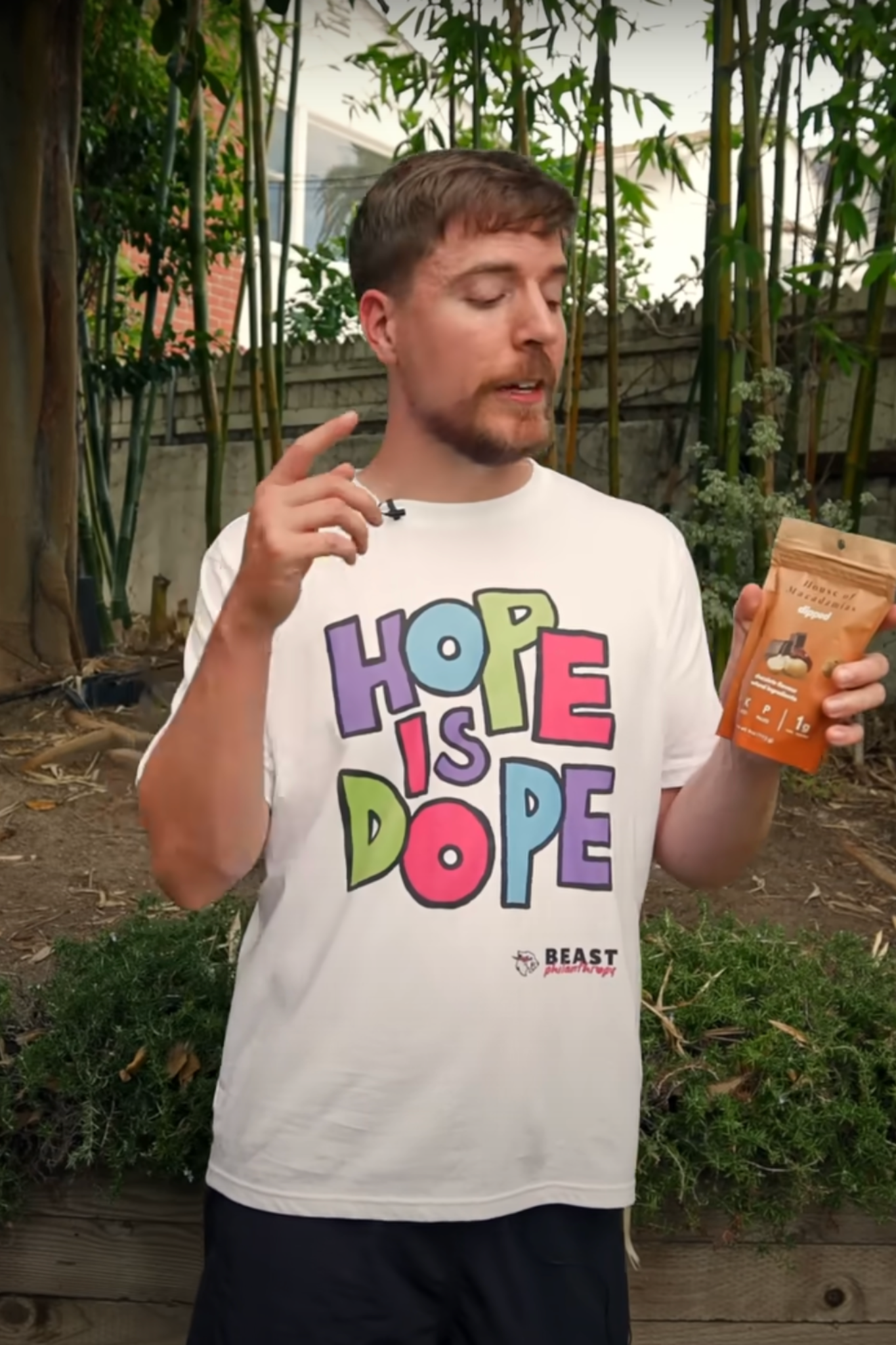 MrBeast holding a bag of House of Macadamias Chocolate Covered Macadamia Nuts — showcasing a popular, vegan, plant-based, and nutrient-dense healthy snack