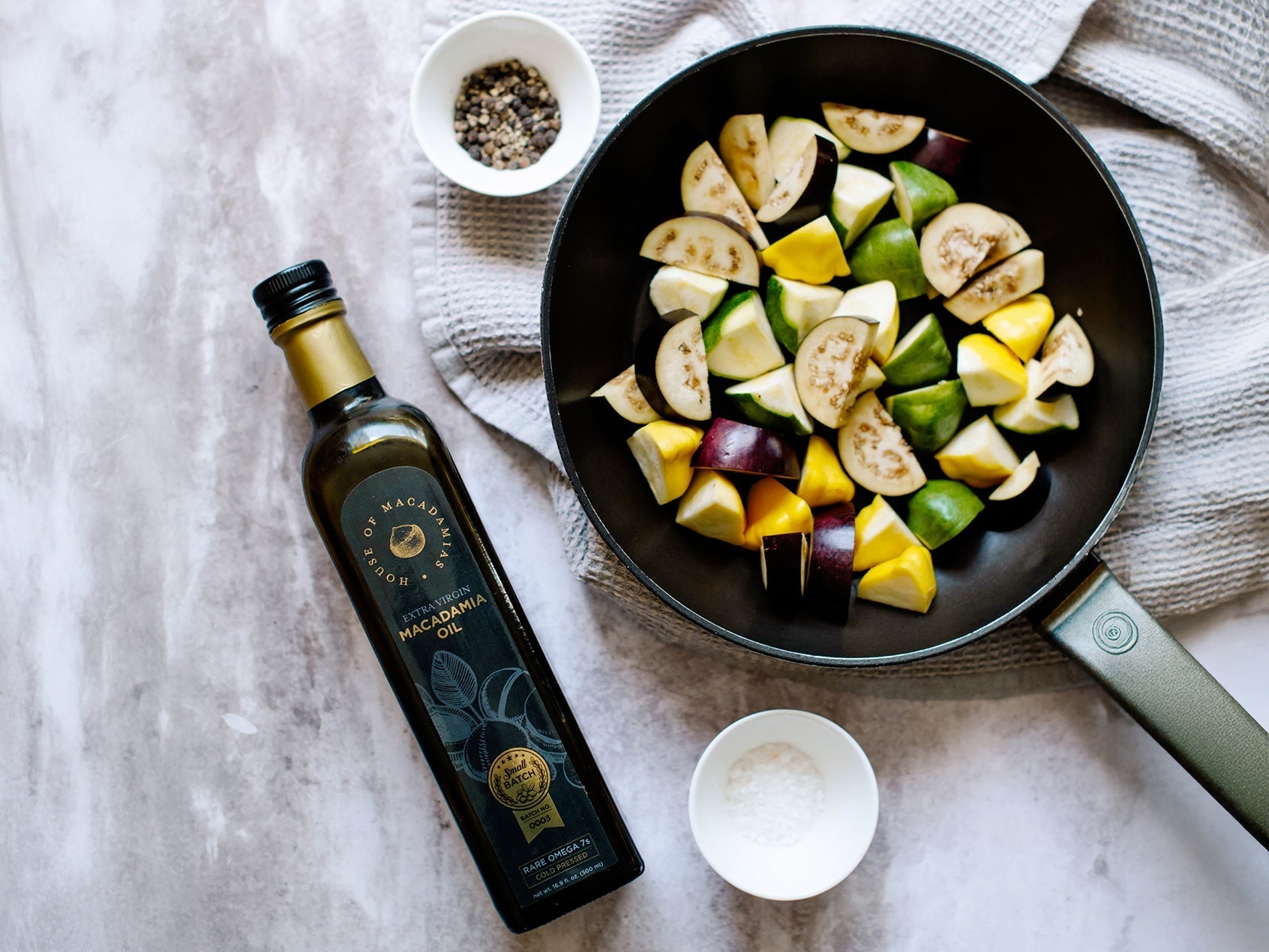 macadamia oil bottle with mediterranean vegetables in a pan for healthy cooking