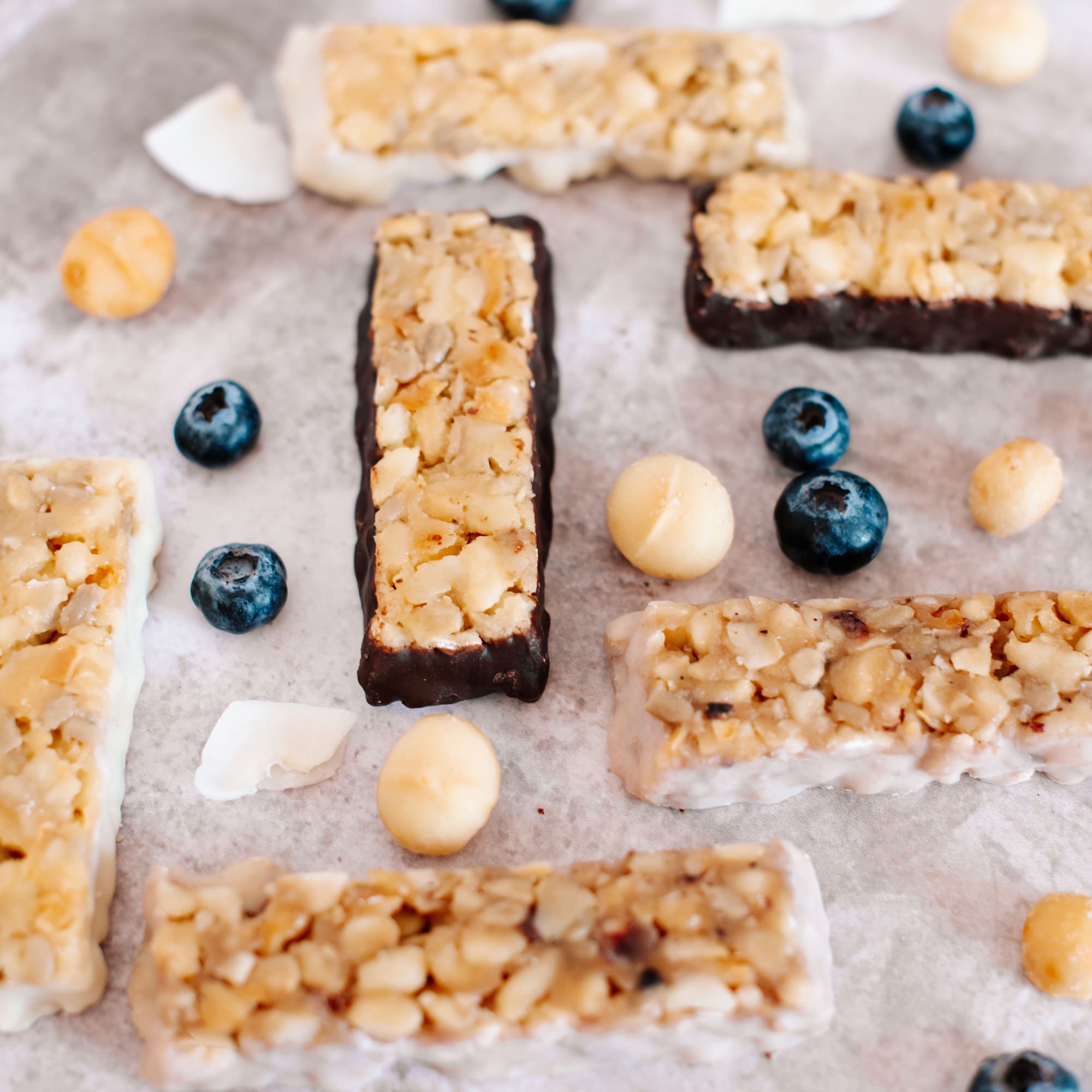 Coconut white chocolate, chocolate, blueberry white chocolate & cocnut white chocolate macadamia snack bar by House of Macadamias, made with macadamias as the first ingredient. Plant based, no seed oils, 100% natural healthy snack bar rich in antioxidants and healthy fats.