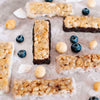 Coconut white chocolate, chocolate, blueberry white chocolate & cocnut white chocolate macadamia snack bar by House of Macadamias, made with macadamias as the first ingredient. Plant based, no seed oils, 100% natural healthy snack bar rich in antioxidants and healthy fats.
