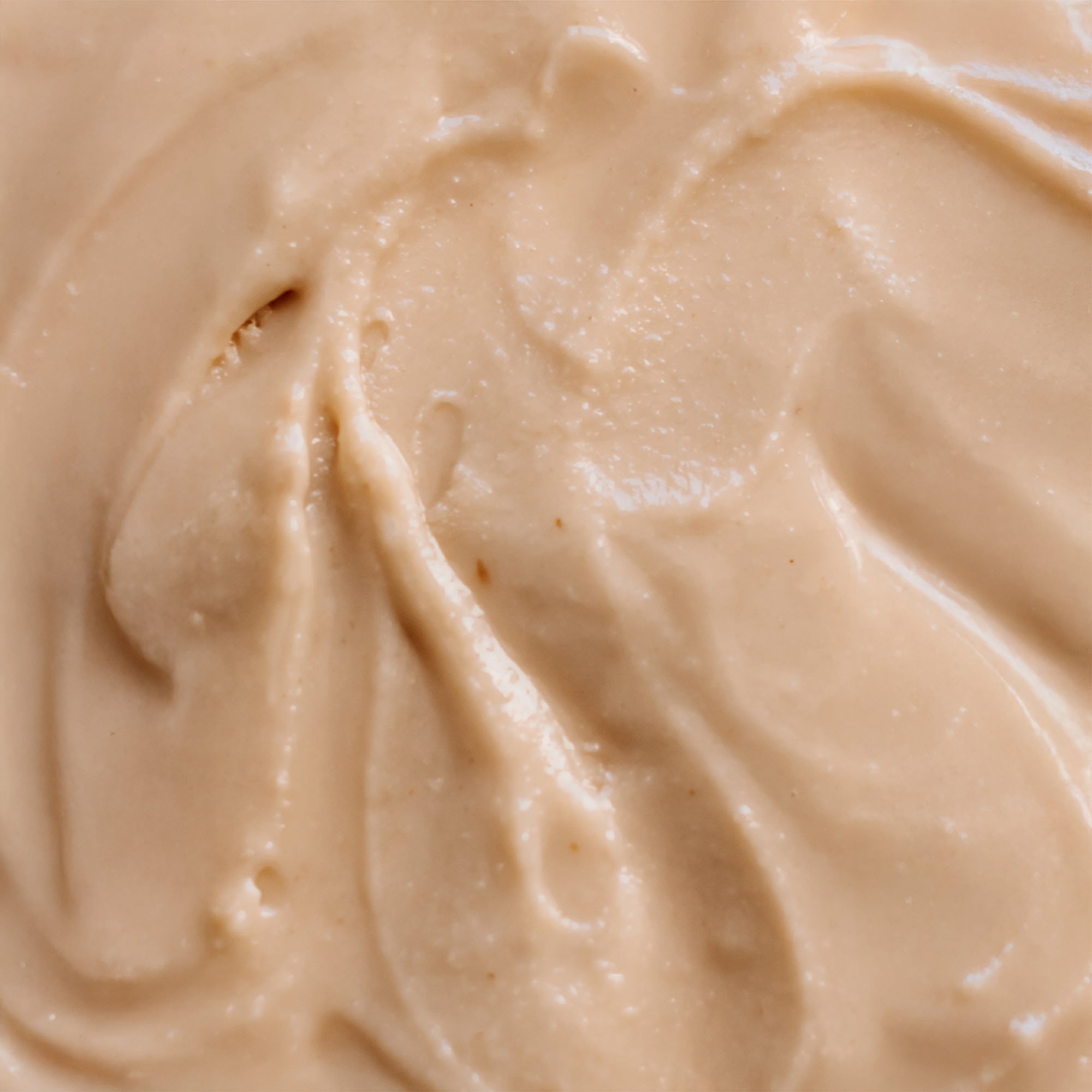Close-up of All Natural Macadamia Nut Butter smeared to highlight creamy texture