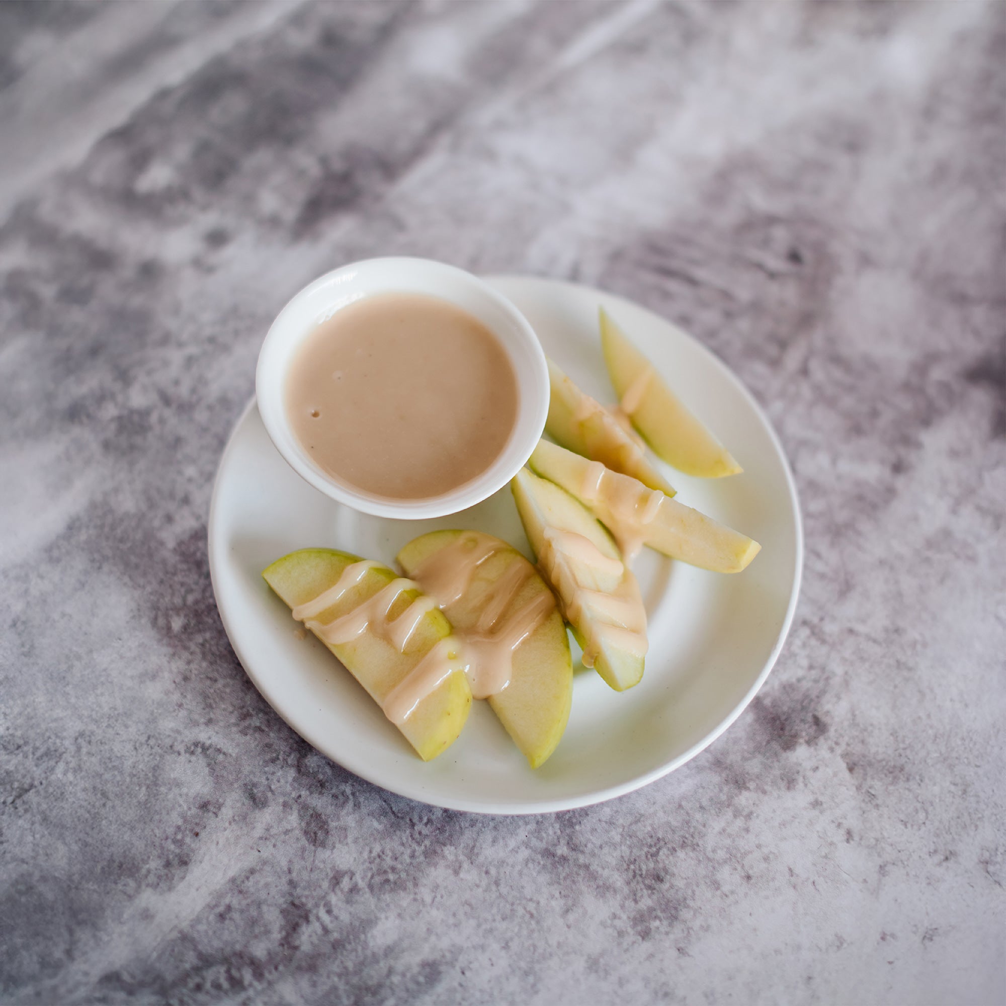 Apple slices served with All Natural Macadamia Nut Butter for dipping