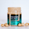 House of Macadamias All Natural Macadamia Nut Butter jar with whole macadamia nuts beside it on a white background