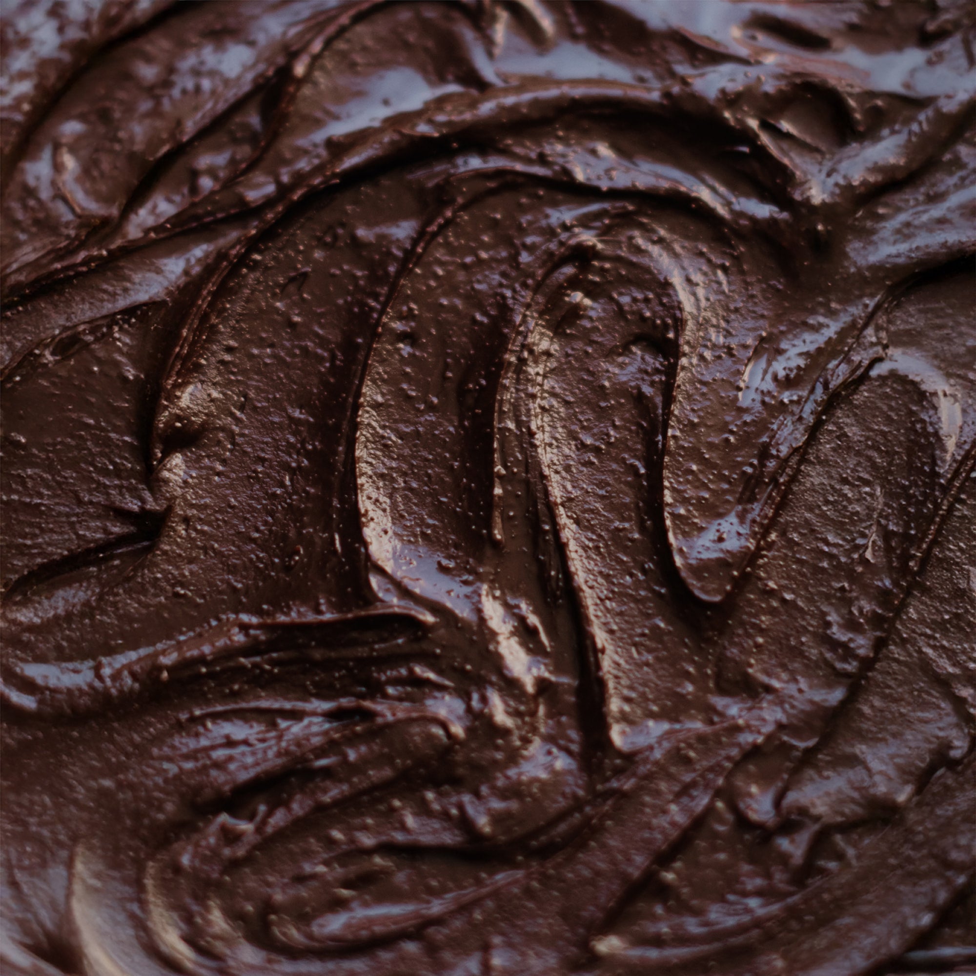 Chocolate Macadamia Nut Butter extreme close-up showing creamy texture, rich in healthy monounsaturated fats and natural ingredients